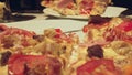 Homemade pizza on a plate close up, woman separates slices with a table knife, turns plate, camera tracking