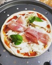 homemade pizza with prosciutto ham and basil Royalty Free Stock Photo