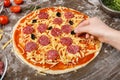 Homemade pizza. Woman adding black olives to pizza Royalty Free Stock Photo