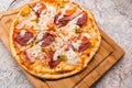 Homemade pizza on a wooden cutting Board on the table closeup