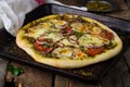 Homemade pizza with zaatar, tomatoes, onion and cheese on wooden background. Eastern cuisine. Selective focus Royalty Free Stock Photo