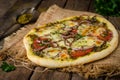 Homemade pizza with zaatar, tomatoes, onion and cheese on wooden background. Eastern cuisine. Selective focus Royalty Free Stock Photo