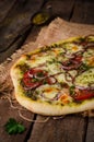 Homemade pizza with zaatar, tomatoes, onion and cheese on wooden background. Eastern cuisine. Selective focus Royalty Free Stock Photo