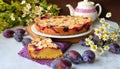 Homemade plum and almond cake made with fresh plums. Delicious cake beautifully decorated in vintage style. Tasty dessert.