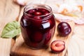 Homemade plum jam in glass jar.