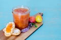 Homemade plum jam. Toasts and plums on wooden board and blue background Royalty Free Stock Photo