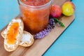 Homemade plum jam. Toasts and plums on wooden board and blue background Royalty Free Stock Photo