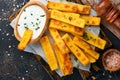 Homemade polenta chips fries with sea salt, parmesan, thyme, rosemary with yogurt sauce. Typical Italian fried polenta. Fried corn Royalty Free Stock Photo