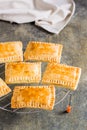 Homemade pop tarts made from scratch on the grid on the table. Vertical view Royalty Free Stock Photo