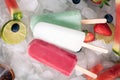 Homemade popsicles on ice and fruits