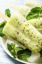 Homemade popsicles with kiwi and lemon on a wooden table Royalty Free Stock Photo