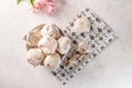 Homemade eggs dessert meringue on a plate on a light background. Next to pink flower and pieces of cookies. Copy space Royalty Free Stock Photo