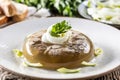 Homemade pork aspic, meat jelly with onion and leek in a white plate Royalty Free Stock Photo