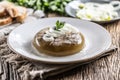 Homemade pork aspic, meat jelly with onion and leek in a white plate Royalty Free Stock Photo