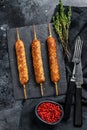 Homemade pork meat kebabs on skewers. Black background. Top view Royalty Free Stock Photo