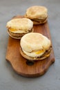 Homemade pork roll egg sandwich on a rustic wooden board on a gray background, side view. Closeup Royalty Free Stock Photo
