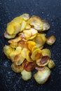 Homemade Potato Chips with Sea Salt on Dark Background