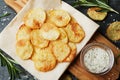 Homemade potato chips with sea salt and herb on cutting board