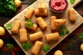 Homemade Potato Croquettes with dipping sauce on wooden board