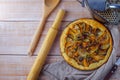 Homemade potato pie with pumpkin and onion on wooden background. Royalty Free Stock Photo