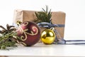 HOMEMADE PRESENT BOX AND BAUBLE. CHRISTMAS ORNAMENT STILL LIFE ON WHITE BACKGROUND