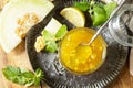 Homemade preserve. Sweet melon and citrus jam or jelly in small glass jar with fresh melon slices on wooden rustic table. View Royalty Free Stock Photo