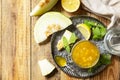 Homemade preserve. Sweet melon and citrus jam or jelly in small glass jar with fresh melon slices on wooden rustic table. View Royalty Free Stock Photo