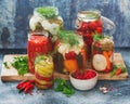 Homemade preserves and pickles of different vegetables in jars Royalty Free Stock Photo