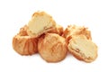 Homemade profiteroles with cream isolated on a white background. Fresh baked golden profiterole