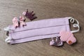 Homemade protective mask and adorable girly hair clips on background, flat lay. Sewing for child