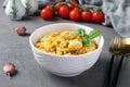 Homemade ptitim pasta with chicken and vegetables on dark gray table. Closeup