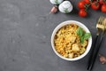 Homemade ptitim pasta with chicken and vegetables on dark gray table. Horizontal format