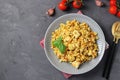 Homemade ptitim pasta with chicken and vegetables on dark gray table. Top view. Space for text