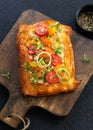 Homemade Puff pastry appetizer tartlet with shrimps, prawns, tomatoes, avocado,vegetables and microgreens on dark background with Royalty Free Stock Photo