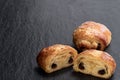 Homemade puff pastry with chocolate stuffed on black stone background