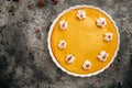 Homemade pumpkin cheesecake with caramel sauce and seeds on top on metal wicker stand Royalty Free Stock Photo