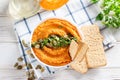 Homemade pumpkin hummus with garlic, lemon and pepper on a plate on the table. Horizontal top view from above Royalty Free Stock Photo