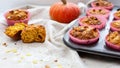 Homemade pumpkin muffins with pumpkin seeds and walnut pieces. Fall baking for Thanksgiving and Halloween. Cupcakes in baking dish Royalty Free Stock Photo