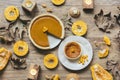 Homemade pumpkin pie with a slice cut out served with raw pumpkin slices. Decorated with candles, dried autumn leaves. Royalty Free Stock Photo