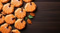 Homemade pumpkin shaped cookies closeup on dark wooden background with copy space top view holiday food concept
