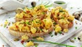 Homemade Quail Scrambled eggs on crispy toast, bread with green onion, chives on white board.