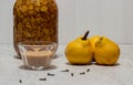 Homemade quince liqueur. Maceration of quinces in water, cane sugar, cinnamon, cloves and alcohol Royalty Free Stock Photo