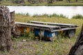 Homemade raft for river rafting. A boat made of planks and old iron barrels. Pontoon. Watercraft