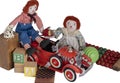 Homemade Raggedy Ann & Andy sit on vintage toys, red fire engine, wood blocks, checkers, ball, counter beads.
