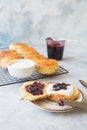 Homemade raisin scones serve with homemade strawberries jam,clotted cream and tea. Scones is English pastry for afternoon Royalty Free Stock Photo