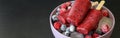 Homemade raspberries blueberries ice cream popsicles on dark background. Royalty Free Stock Photo