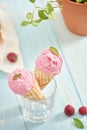 Homemade raspberry ice cream in waffle cones on rustic wooden ba Royalty Free Stock Photo