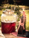Homemade raspberry liqueur in front of garden Royalty Free Stock Photo