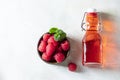 Homemade raspberry vinegar and fresh raspberries
