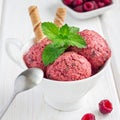 Homemade raspberry, yogurt, chocolate chips ice cream balls in cup on white wooden table, square Royalty Free Stock Photo